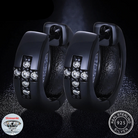 A pair of black Moissanite diamond cross earrings with a cross design, featuring lab-created moissanite stones set in a black band, with the brand's logo and 'REAL SILVER' stamp.