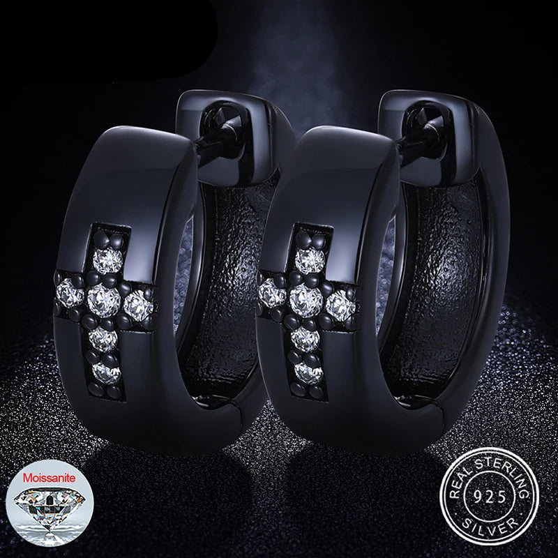 A pair of black Moissanite diamond cross earrings with a cross design, featuring lab-created moissanite stones set in a black band, with the brand's logo and 'REAL SILVER' stamp.