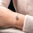 Silver bracelet on a wrist with a soft background