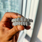 A set of 18k gold diamond grillz in various designs, showcasing the top and bottom teeth with sparkling diamonds.