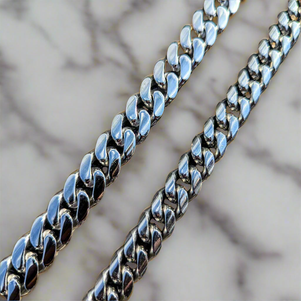 Close-up of a silver chain on a blurred natural background